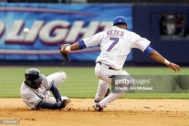 Jose Reyes of the New York Mets bobbles the ball allowing Tony Womack of the New York Yankees to slide in safely during a double play attempt in the...