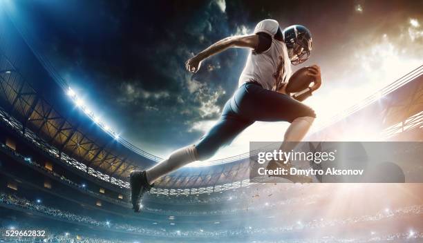 football player runs with the ball - offense sporting position stock pictures, royalty-free photos & images