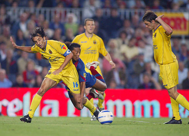 Ronaldinho of Barcelona and Quique Alvarez of Villarrea are seen in action during the La Liga match between FC Barcelona and Villarreal on May 22,...