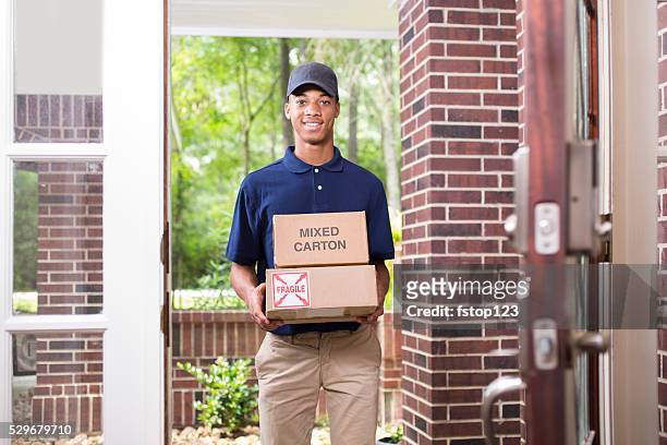 young man delivers packages to customer at home. - answering door stock pictures, royalty-free photos & images