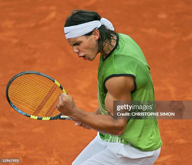 Spanish Rafael Nadal celebrates after winning against German Lars Burgsmuller after their match for the first round of the tennis French Open at...