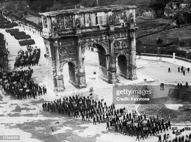 Former soldiers march along the new road of Triumph in Rome, past the Arch of Constantine, to celebrate the 11th anniversary of the March on Rome and...