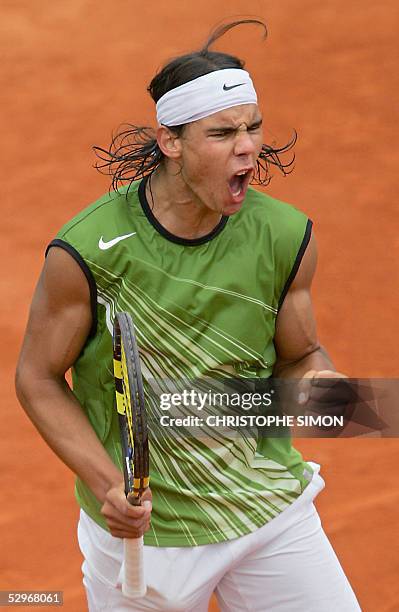 Spanish Rafael Nadal celebrates winning against German Lars Burgsmuller after their match for the first round of the tennis French Open at Roland...