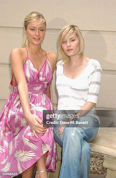 Socialite/actress Paris Hilton and actress Elisha Cuthbert pose at a photocall to promote her new movie "House of Wax" at 5 Cavendish Square on May...