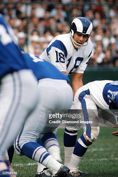 Quarterback Roman Gabriel of the Los Angeles Rams calls out the signals during a game in late1960's against the Detroit Lions at Tiger Stadium in...