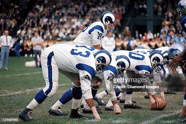 Quarterback Roman Gabriel of the Los Angeles Rams calls out the signals at the line of scrimmage during a game in the late 1960's against the Detroit...