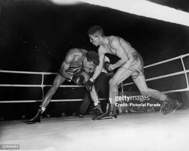 English professional boxer Randolph Turpin demonstrates his crouching style to American professional boxer Sugar Ray Robinson during the World...