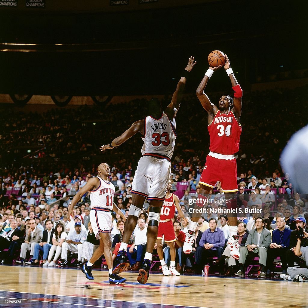 Hakeem Olajuwon of the Houston Rockets takes a jumpshot over Patrick ...