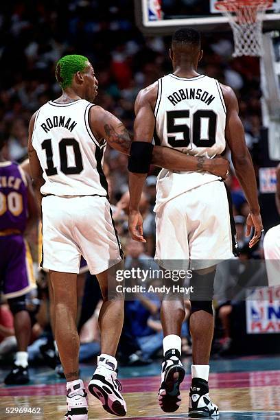 Dennis Rodman and David Robinson of the San Antonio Spurs walk the floor during a break in their NBA game against the Los Angeles Lakers on May 8,...