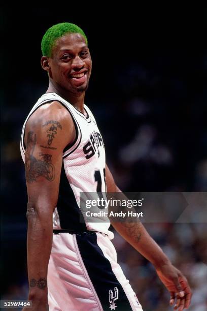 Dennis Rodman of the San Antonio Spurs smiles during a break in the NBA game against the Los Angeles Lakers on May 8, 1995 in San Antonio, Texas....