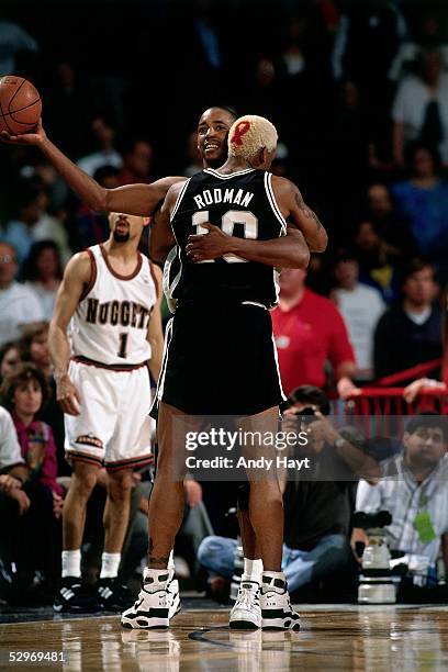 Dennis Rodman and Sean Elliott of the San Antonio Spurs celebrate during Game 3, Round 1 of the 1995 NBA Playoffs against the Denver Nuggets on May...