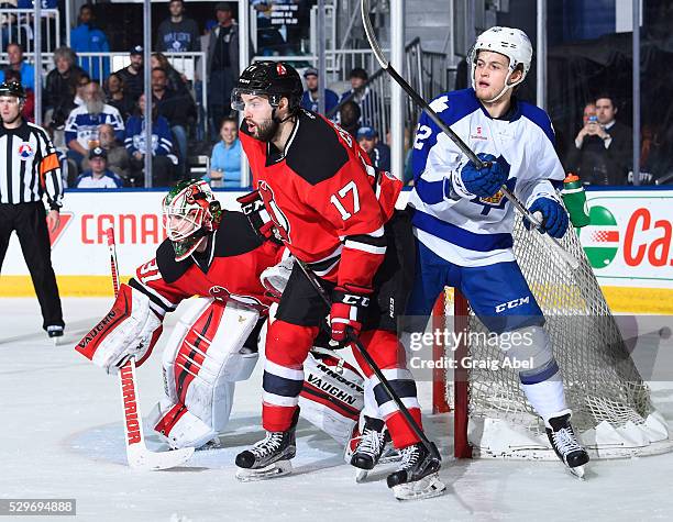 William Nylander of the Toronto Marlies battles for crease space with Scott Wedgewood and Marc-Andre Gragnani of the Albany Devils during AHL playoff...