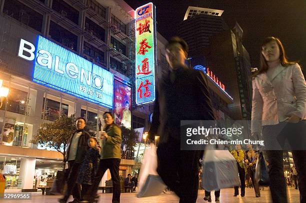 Shoppers outside a mall on March 25, 2005 in Chongqing, Sichuan province in southwest China. Investment bank Credit Suisse First Boston predicts...