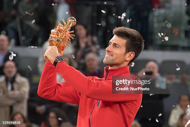 Novak Djokovic of Serbia holds aloft his winners trophy after his three set victory against Andy Murray of Great Britain in the mens final during day...