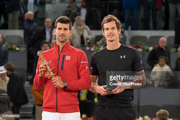Serbia's Novak Djokovic and Britain's Andy Murray pose with their trophies after the Madrid Open men's tennis final at the Caja Magica sports complex...