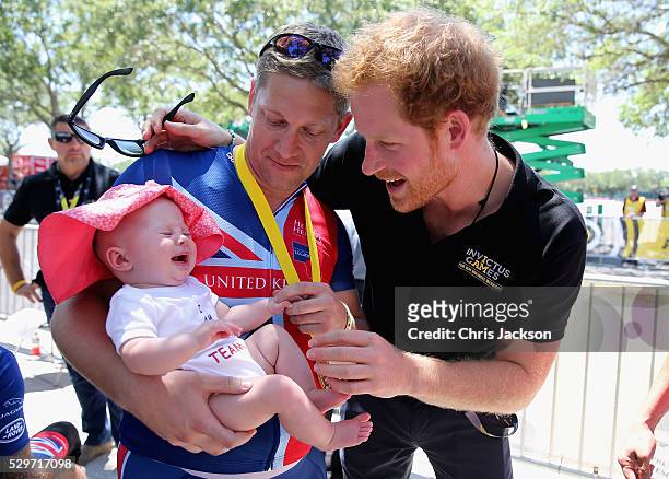 British double gold winner Rob Cromey-Hawke and his daughter Pippa meet Prince Harry at the road cycling event during the Invictus Games Orlando 2016...