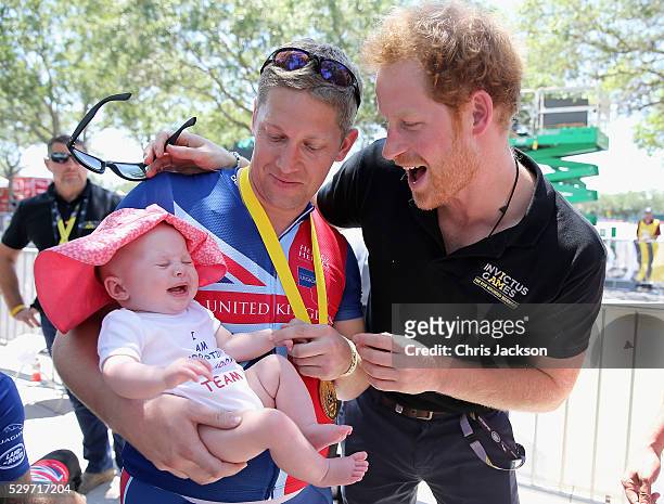 British double gold winner Rob Cromey-Hawke and his daughter Pippa meet Prince Harry at the road cycling event during the Invictus Games Orlando 2016...