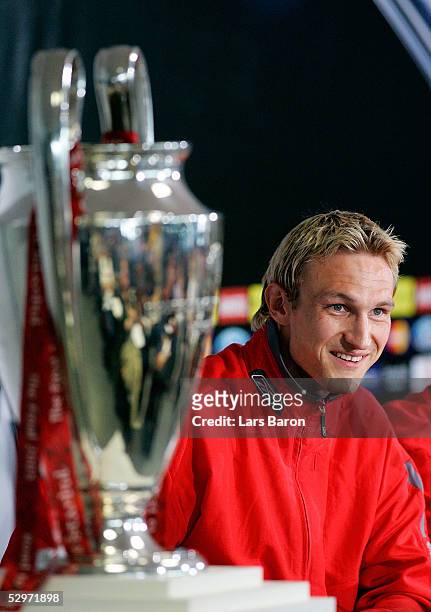 Liverpool's defender Sami Hyypia of Finland looks a cross at the Champions League Trophy during a press conference ahead of the European Champions...