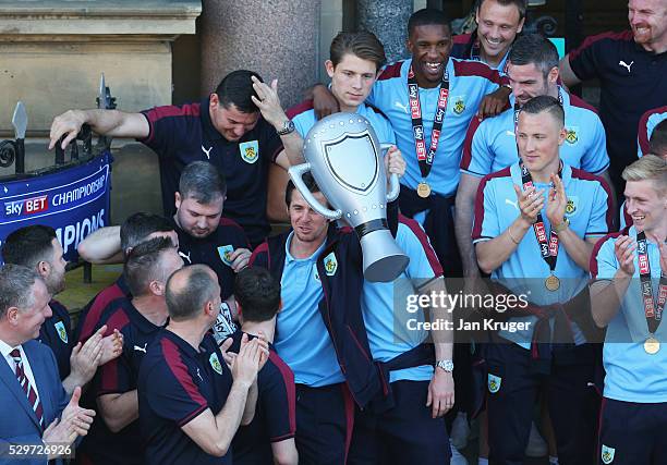 Medalless Joey Barton celebrates with an inflatable trophy as Sky Bet Champions Burnley are presented with the Championship trophy at the Town Hall...