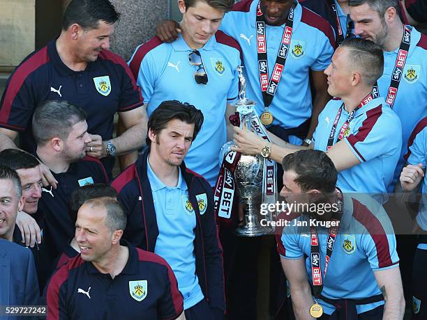 Medalless Joey Barton looks on alongside team mates as Sky Bet Champions Burnley are presented with the Championship trophy at the Town Hall on May...