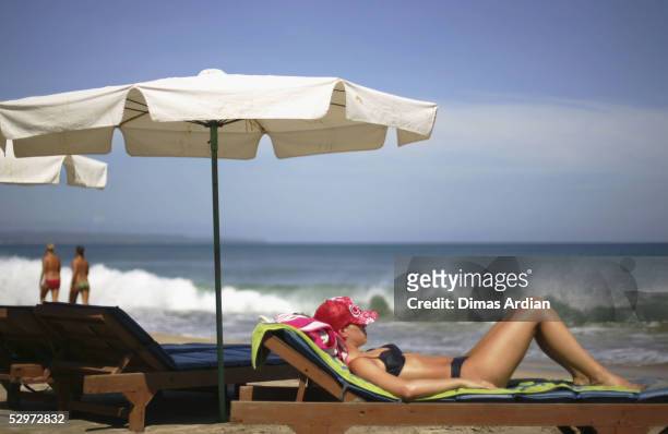 Tourist sunbathes on Kuta Beach on May 24, 2005 in Bali, Indonesia. Australian travel agents have threatened to stop promoting Bali as a destination...