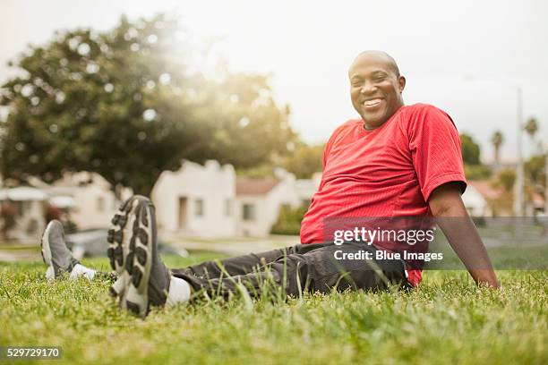 man exercising on grass - chubby men stock-fotos und bilder