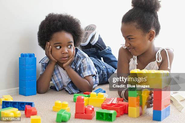 brother and sister making faces at each other - sibling rivalry stock pictures, royalty-free photos & images