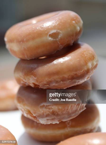 In this photo illustration, Krispy Kreme Donuts are seen on May 09, 2016 in Miami, Florida. JAB Holdings Company, announced it is acquiring Krispy...