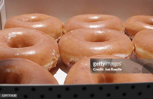 In this photo illustration, Krispy Kreme Donuts are seen on May 09, 2016 in Miami, Florida. JAB Holdings Company, announced it is acquiring Krispy...