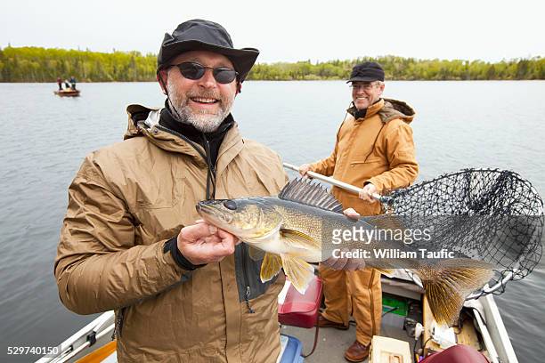 fisherman showing catch - man catching stock pictures, royalty-free photos & images