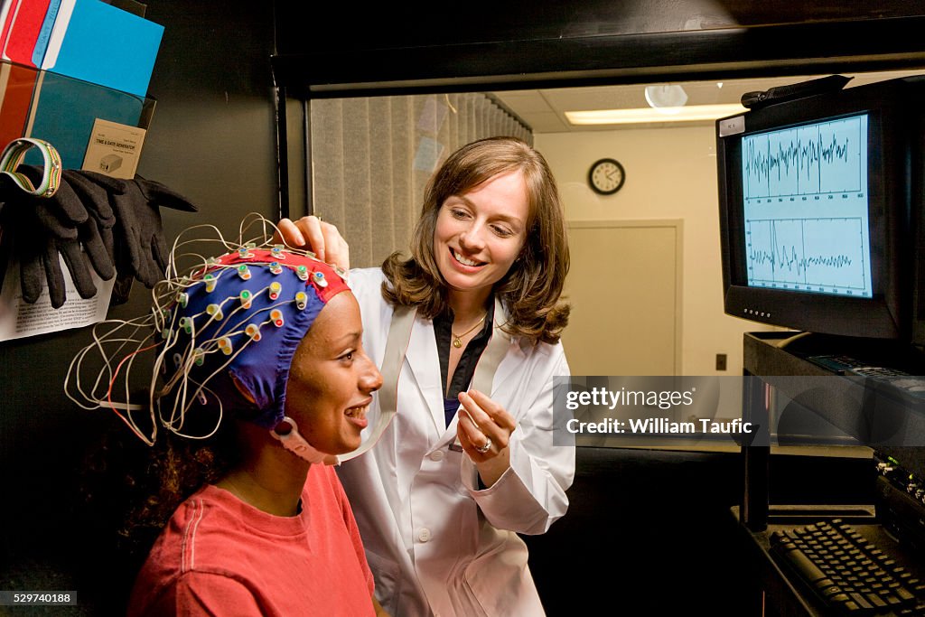 Doctor and patient with electrodes on head
