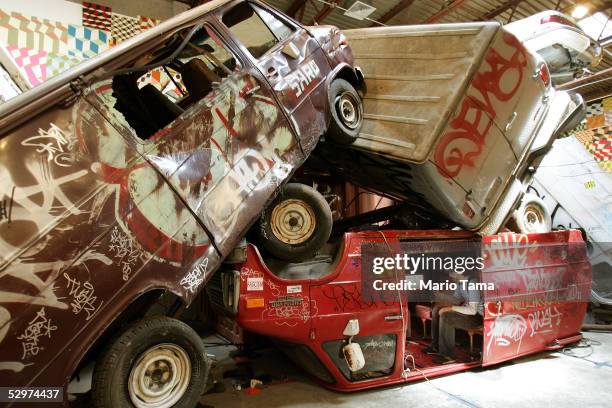 Visitor sits inside a van that is part of the urban street art installation 'One More Thing' by artist Barry McGee May 24, 2005 in New York City. The...