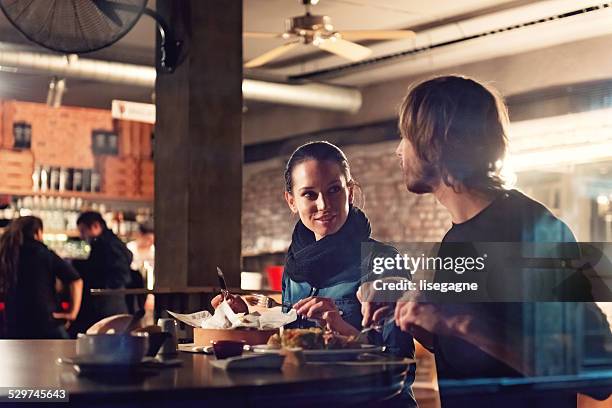 young people in a club having drink and snack - restaurant night stock pictures, royalty-free photos & images