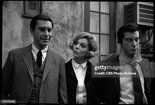 American actress Barbara Bain stands between her husband, American actor Martin Landau , and an actor who wears a mask with Landau's likeness in an...