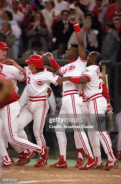 Eric Davis of the Cincinnati Reds celebrates with teammates at the end of Game two of the 1990 World Series against the Oakland Athletics at...