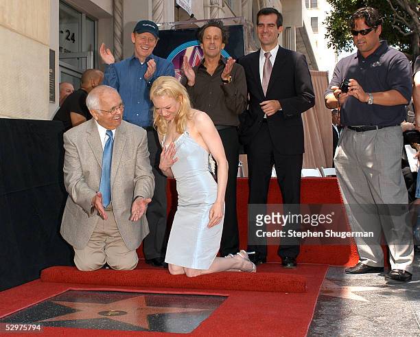 Actress Renee Zellweger poses with Hollywood Mayor Johnny Grant, director Ron Howard, producer Brian Grazer, Councilman Eric Garcetti and brother...