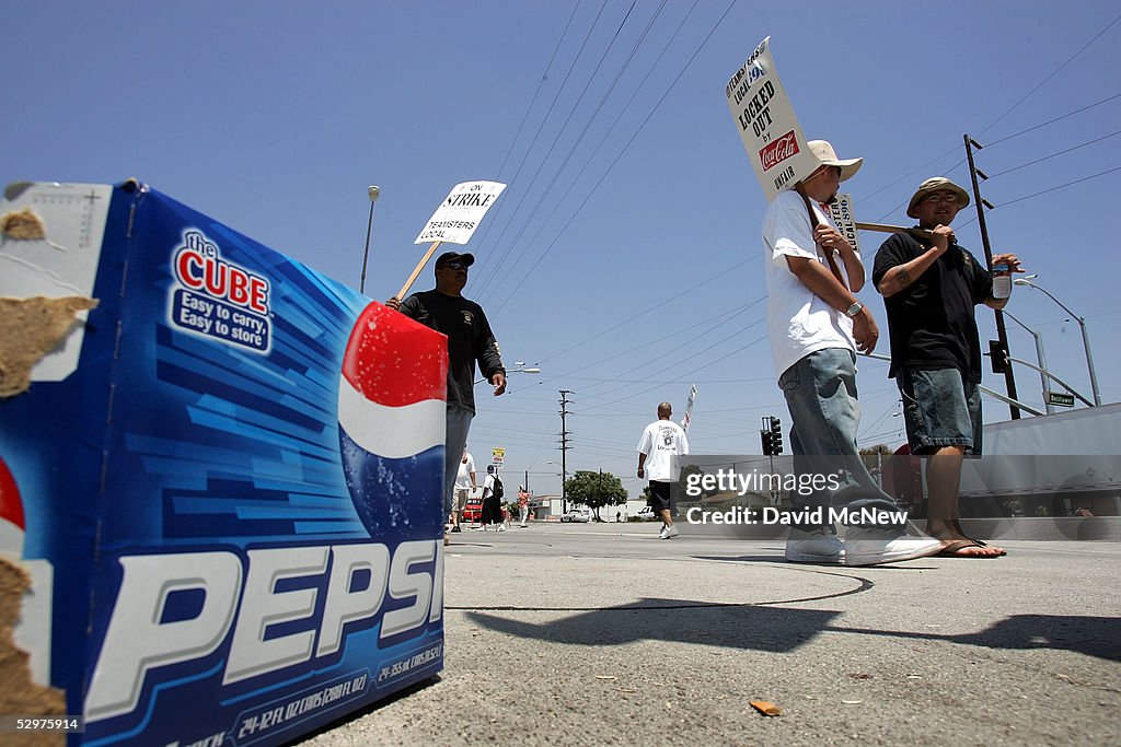 Protesting Coca Cola Picketing Cola-Cola employees walk past an empty Pepsi carton they ...