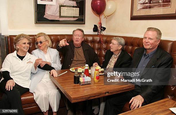 Suzanne Pleshette serves lunch to Barbara Davis, Tom Poston, an unidentified guest and Jon Voight at a party celebrating the 60th anniversary of Nate...