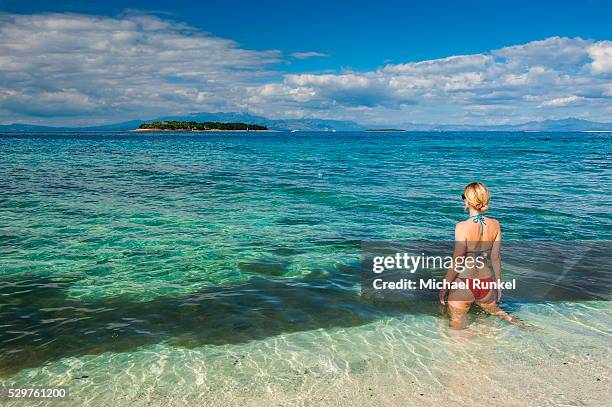 woman standing in the clear water around beachcomber island, mamanucas islands, fiji, south pacific, pacific - beachcomber island stock pictures, royalty-free photos & images