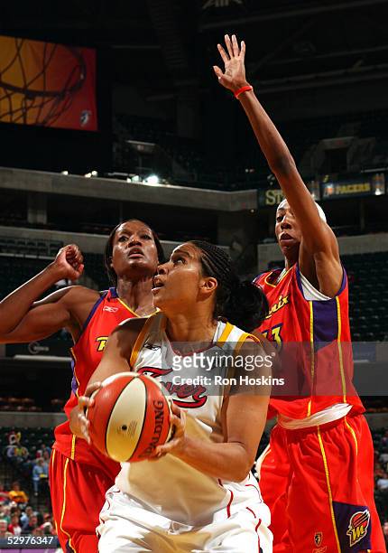 Natalie Williams of the Indiana Fever looks to score over Ashley Robinson and Angelina Williams of the Phoenix Mercury on May 24, 2005 at Conseco...