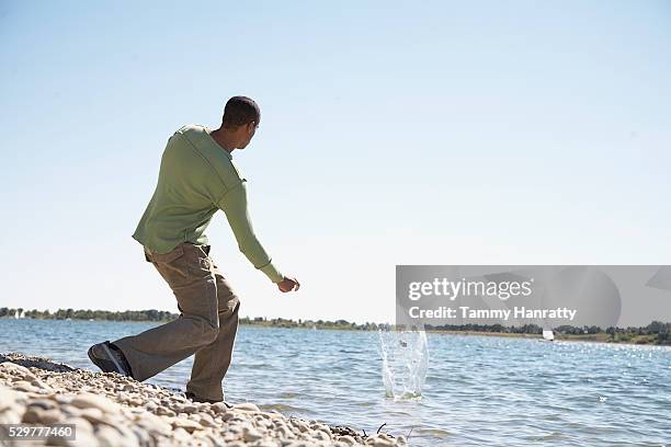 Man Throwing Rock Photos and Premium High Res Pictures - Getty Images