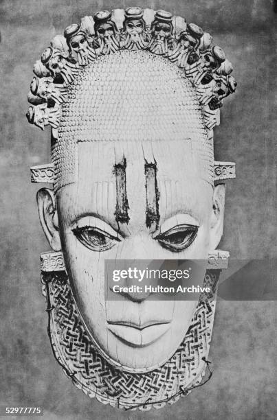 An elaborate 16th century ivory mask from Benin City, Nigeria, circa 1930.