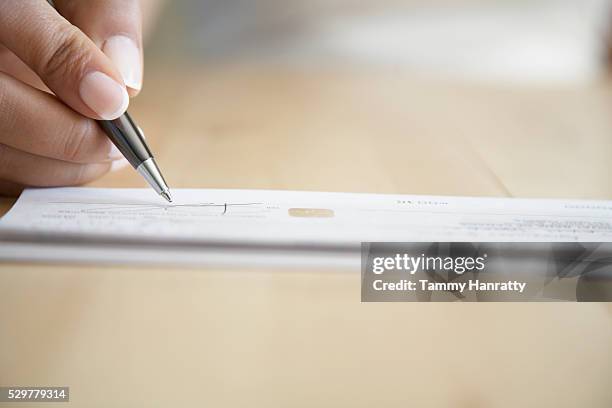 Signing Cheque 192 Person Signing A Cheque Stock Photos, High-Res Pictures, and Images ...
