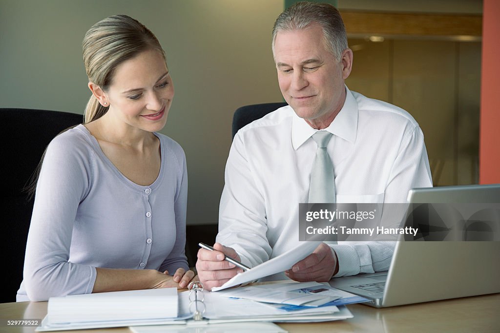 Business colleagues looking at documents