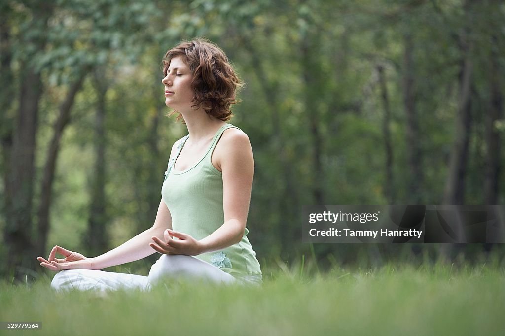 Woman meditating at the park