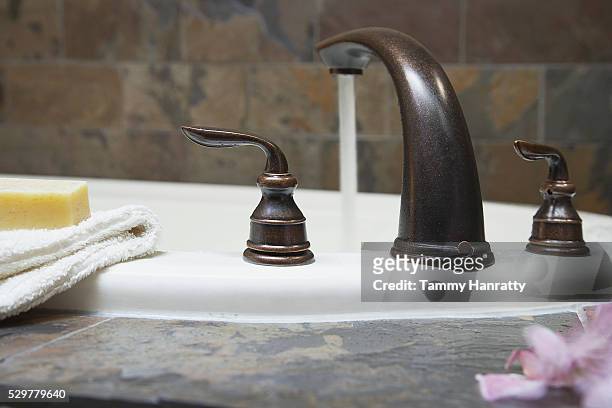 bathroom faucet - washcloth stock-fotos und bilder