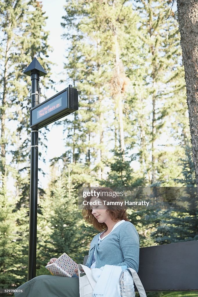 Woman waiting at bus stop