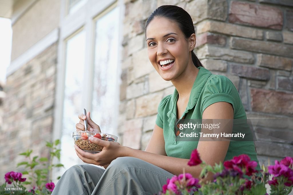 Woman eating breakfast outdoors