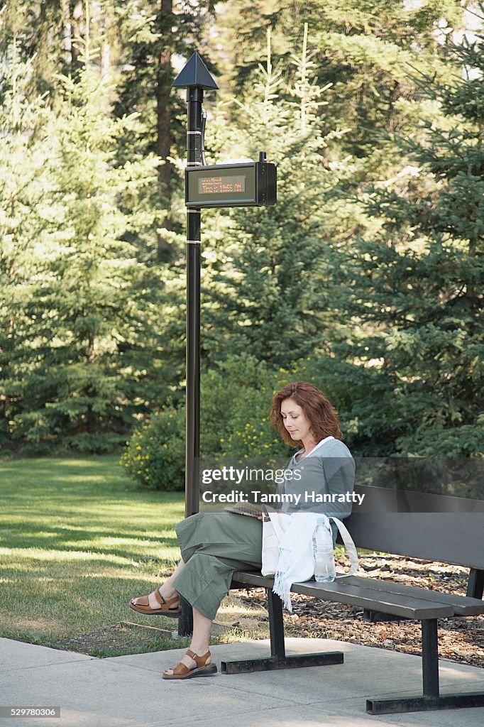 Woman waiting at bus stop