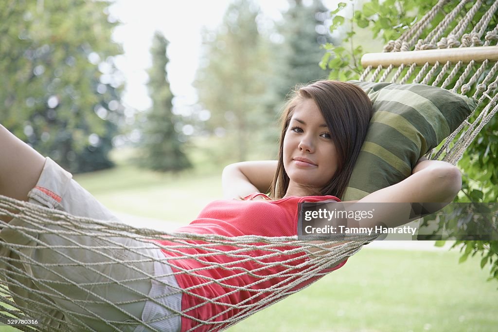 Young woman relaxing in hammock